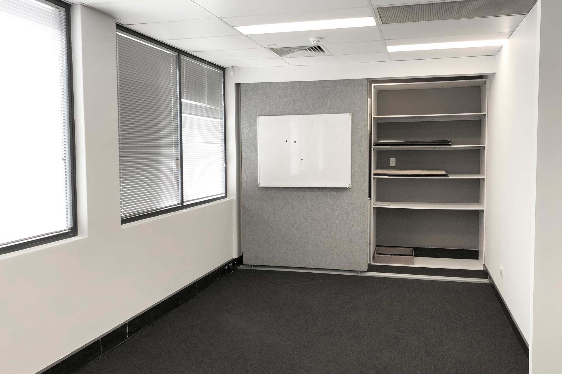 office with shelves and a whiteboard