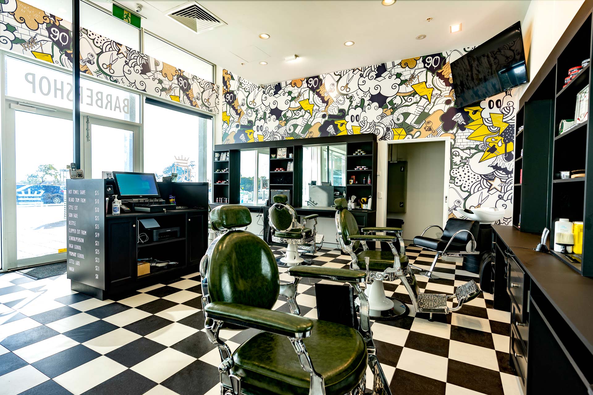 Barbershop fitout design with chequered flooring and jazzy wallpaper
