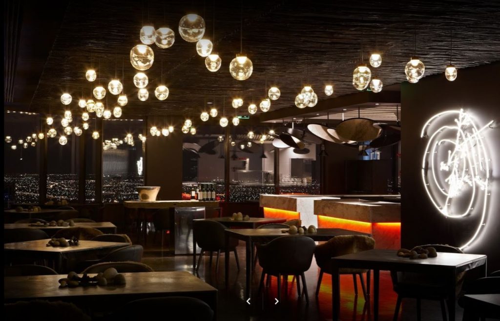 Dimly lit Perth restaurant at night with trendy light bulbs hanging from the ceiling