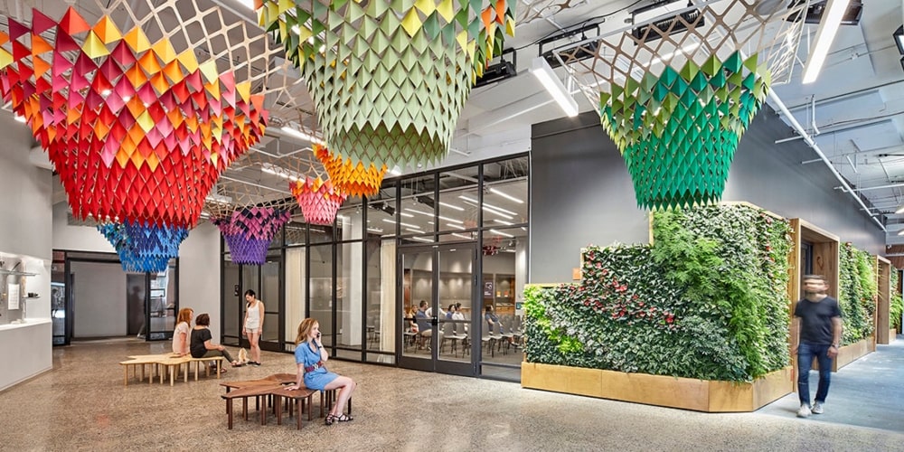 Large office walkway with avant-garde paper chandeliers hanging from the ceiling