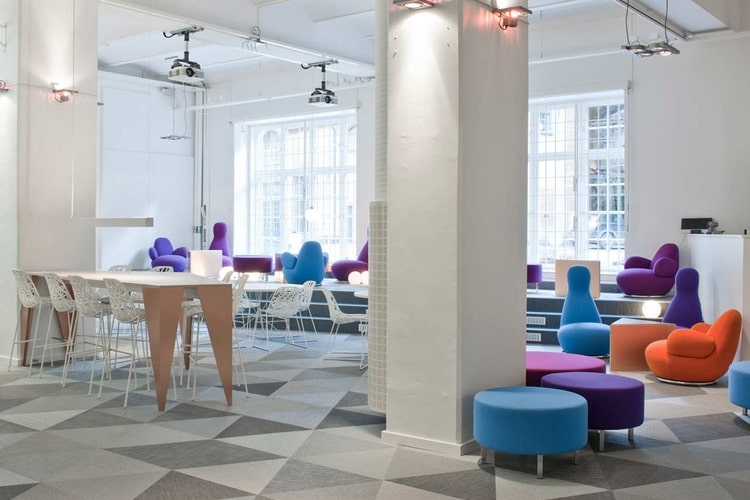 Well lit office space with bright and colorful chairs