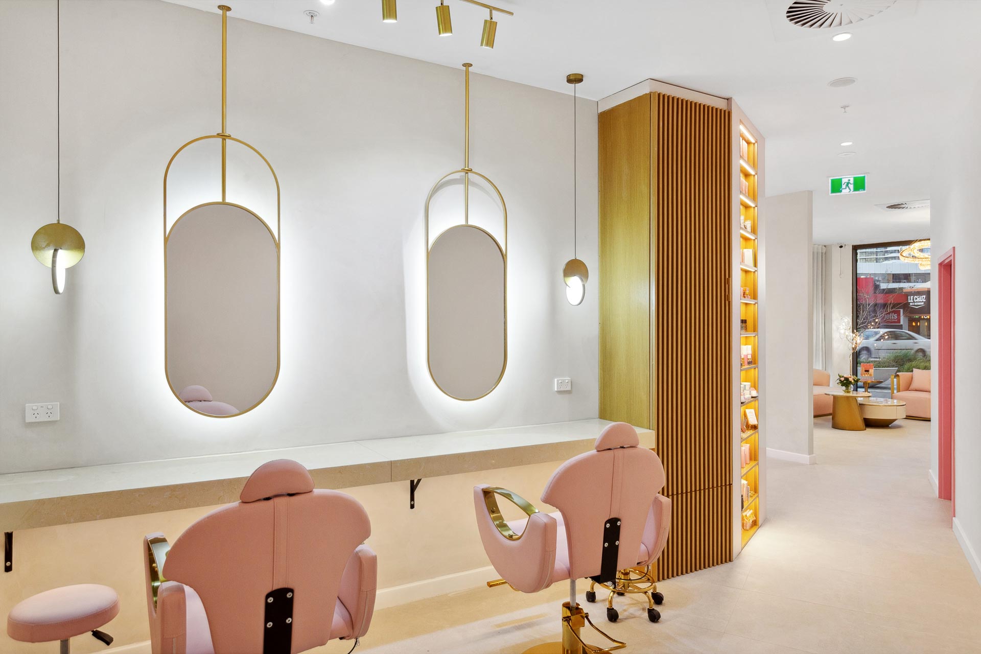 Luxury fiout of Posh Deluxe which features pale pink chairs and gold mirrors.