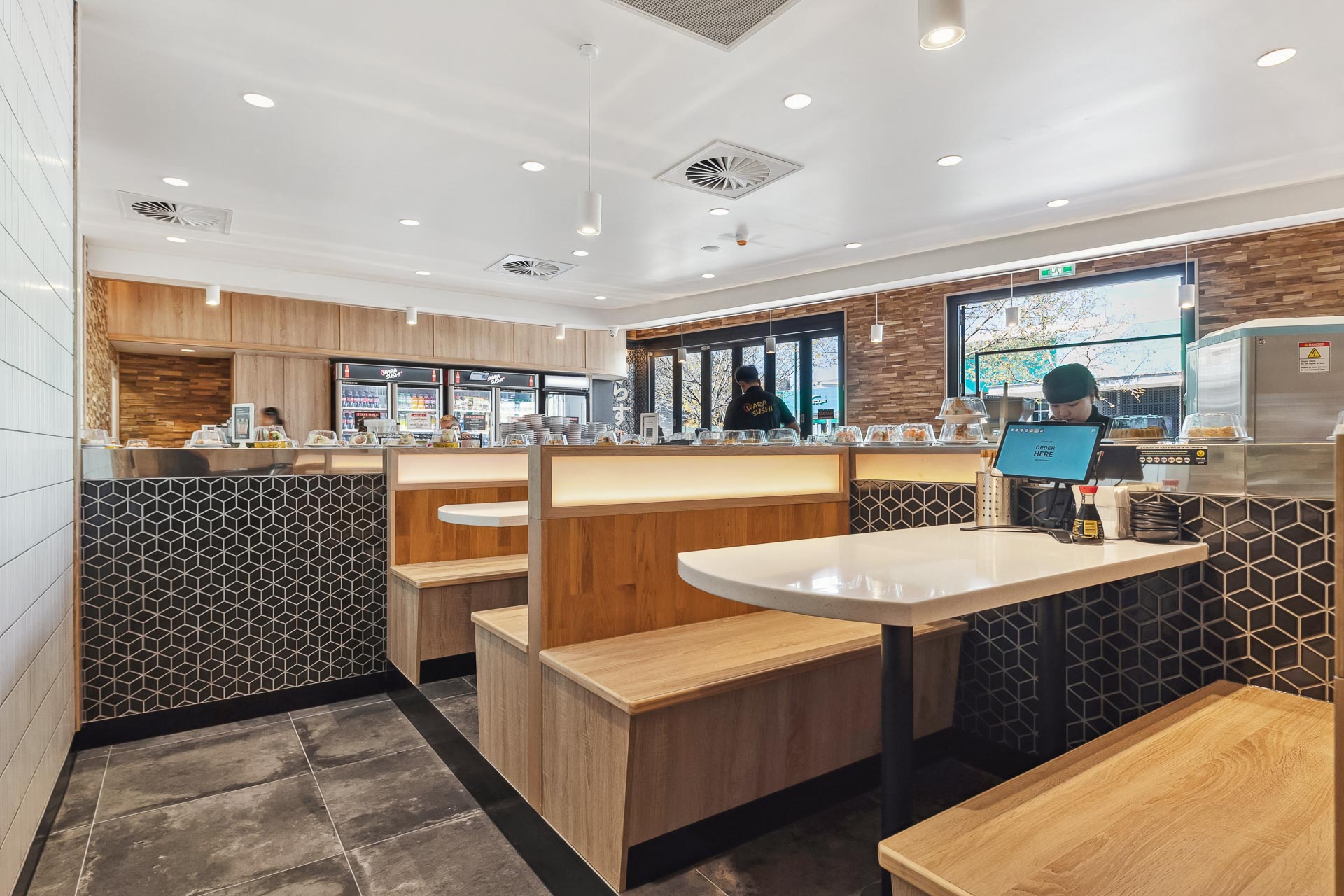 The interior fitout of Wara Sushi in Rockingham, featuring wooden seating booths.