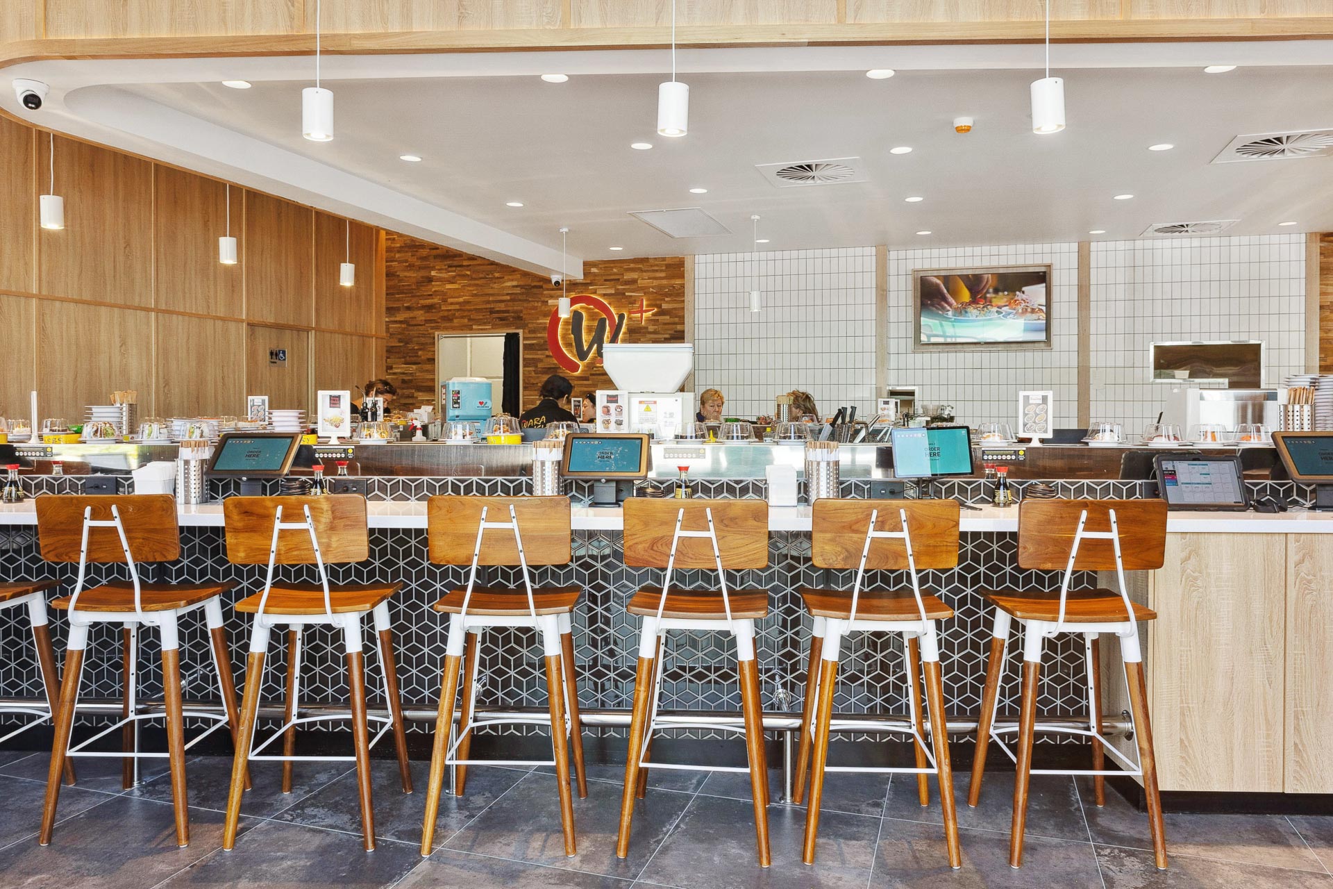 The interior fitout of Wara Sushi in Rockingham, featuring wooden stools around a sushi train