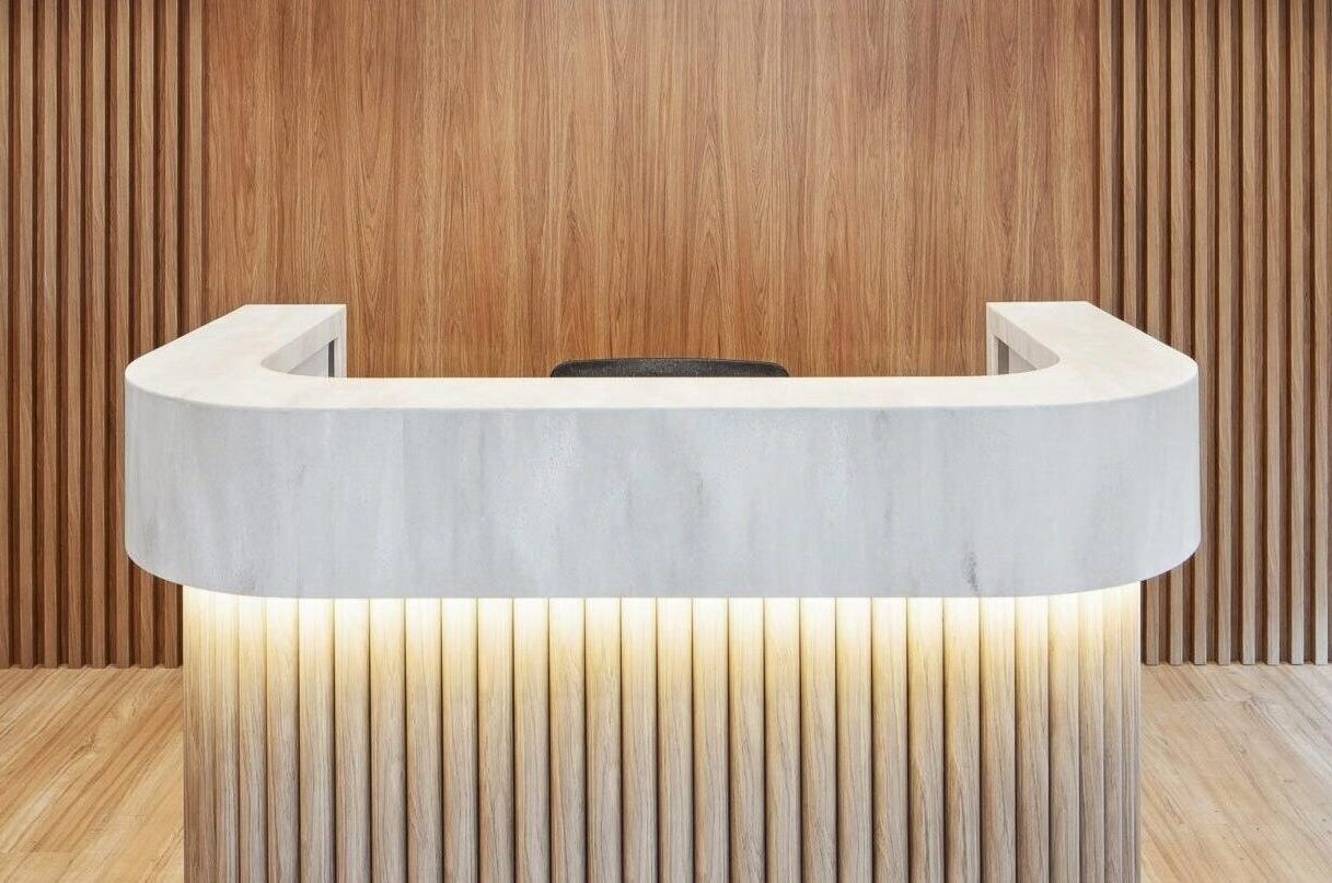 what will replace engineered stone - Front desk of RACGP office, highlighting the use of natural stone for the benchtop